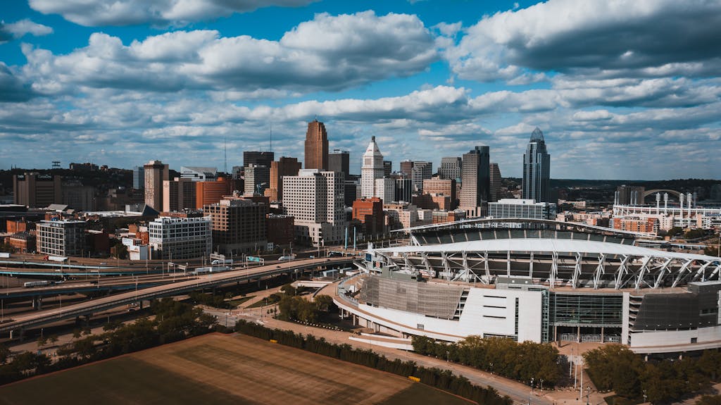 A stunning aerial view of Cincinnati's skyline including Paul Brown Stadium under a clear summer sky.