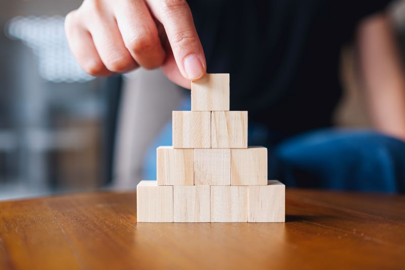 closeup of a hand stacking blocks