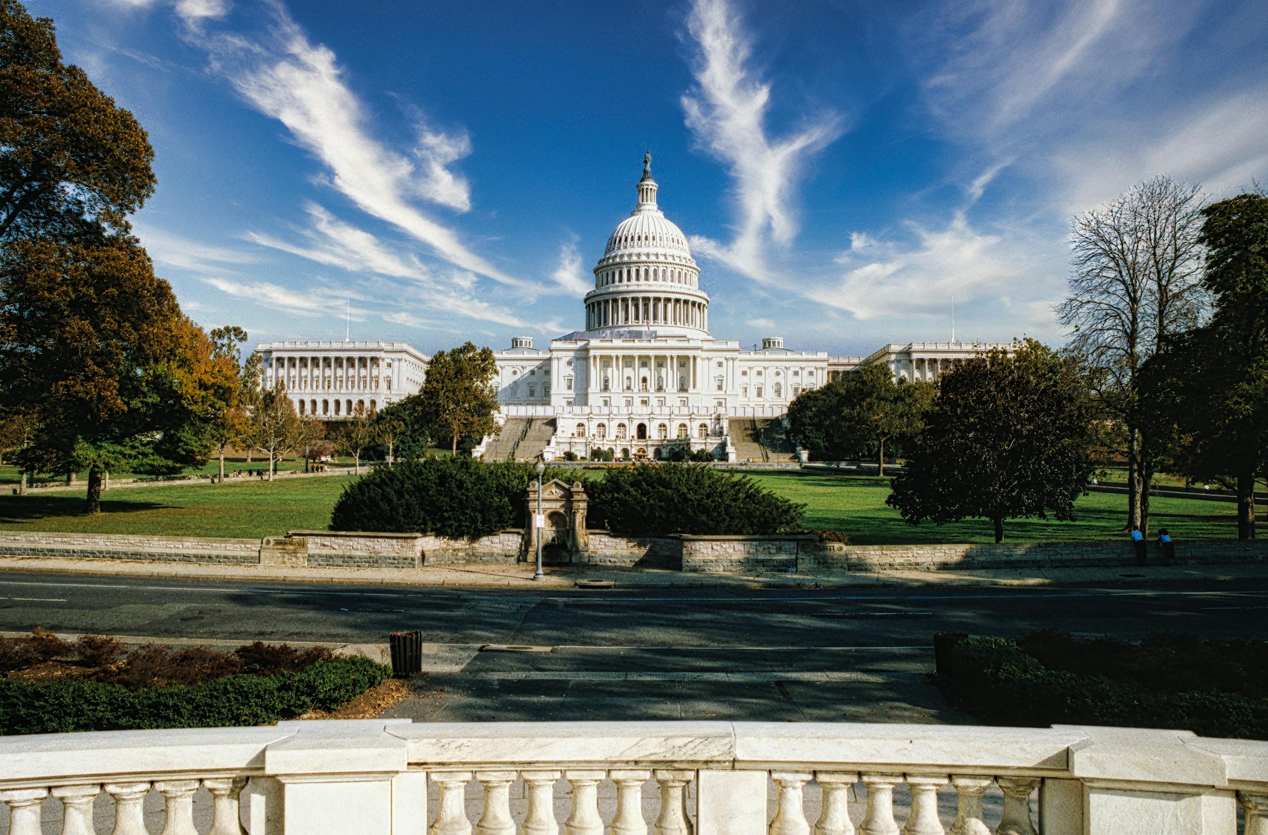 Panoramic view of the United States Capitol in Washington, D.C. under a clear blue sky.
